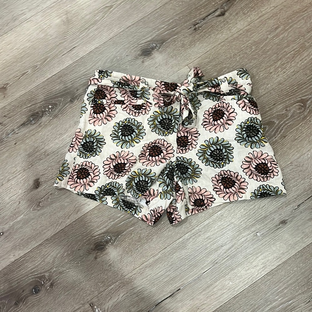 Cream, pink, rust, blue shorts with belt. Front and back pockets